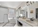 Bright bathroom featuring double sink vanity, soaking tub, and separate shower with black trim at 1006 Henny Pl, Raleigh, NC 27614