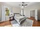 Staged bedroom showcasing hardwood floors, neutral colors, and multiple windows at 1006 Henny Pl, Raleigh, NC 27614