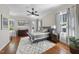 Staged bedroom showcasing hardwood floors, neutral colors, and multiple windows at 1006 Henny Pl, Raleigh, NC 27614