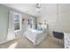 Bright bedroom with whitewashed wood paneling, large windows, and a hanging swing chair at 1006 Henny Pl, Raleigh, NC 27614