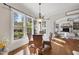 Bright breakfast nook featuring hardwood floors, a glass table, and large windows with views of the backyard at 1006 Henny Pl, Raleigh, NC 27614