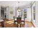 Cozy dining area with hardwood floors, natural light, and elegant chandelier at 1006 Henny Pl, Raleigh, NC 27614