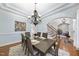 Dining room with hardwood floors, a chandelier, and light blue walls at 1006 Henny Pl, Raleigh, NC 27614