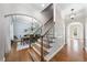 A view of the foyer and dining room with beautiful wood floors and stairs at 1006 Henny Pl, Raleigh, NC 27614