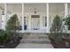 Inviting front entrance featuring stone steps and a covered porch with white columns at 1006 Henny Pl, Raleigh, NC 27614