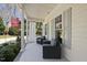 Covered front porch featuring white columns, cushioned chairs, a table, and neutral colored decor at 1006 Henny Pl, Raleigh, NC 27614