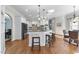 Modern kitchen featuring an island with barstool seating, granite countertops, and stainless steel appliances at 1006 Henny Pl, Raleigh, NC 27614