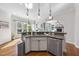 Gourmet kitchen with stainless steel appliances, granite countertops, and a view to the living room at 1006 Henny Pl, Raleigh, NC 27614