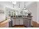 Kitchen with stainless steel appliances, granite countertops, hardwood floors, and a view into the living room at 1006 Henny Pl, Raleigh, NC 27614