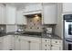 Close-up of kitchen featuring granite countertops, custom cabinetry, and modern appliances at 1006 Henny Pl, Raleigh, NC 27614