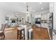 Open-concept kitchen with an island, stainless steel appliances, and a seamless flow to the living area at 1006 Henny Pl, Raleigh, NC 27614