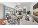 Bright living room with a stone fireplace, built-in shelves, and large windows at 1006 Henny Pl, Raleigh, NC 27614