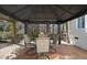 Covered patio featuring a table and four chairs, perfect for outdoor dining and entertaining at 1006 Henny Pl, Raleigh, NC 27614