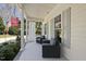 Relaxing front porch featuring comfortable chairs and stylish decor with natural lighting at 1006 Henny Pl, Raleigh, NC 27614