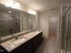 Bright bathroom featuring granite countertop with double sinks, walk-in shower, and separate water closet at 1022 Azimuth Dr, Durham, NC 27713