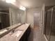 Bright bathroom featuring granite countertop with double sinks, walk-in shower, and separate water closet at 1022 Azimuth Dr, Durham, NC 27713