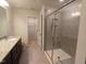 Bathroom featuring granite countertop with single sink and walk-in shower with a glass door at 1022 Azimuth Dr, Durham, NC 27713