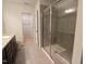 Bathroom featuring granite countertop with single sink and walk-in shower with a glass door at 1022 Azimuth Dr, Durham, NC 27713