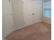 Bedroom featuring neutral carpeting, double window allowing for ample natural light and a spacious closet at 1022 Azimuth Dr, Durham, NC 27713