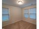 Cozy bedroom with neutral carpet, two windows with blinds, and a ceiling light for comfortable living at 1022 Azimuth Dr, Durham, NC 27713