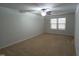 Spacious bedroom featuring neutral carpeting, ceiling fan, and double window allowing for ample natural light at 1022 Azimuth Dr, Durham, NC 27713