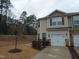 Traditional two-story townhome featuring stone accents, attached garage, and landscaped front yard at 1022 Azimuth Dr, Durham, NC 27713