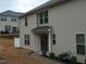Well-maintained exterior of townhome with covered entryway, private parking, and landscaped front yard at 1022 Azimuth Dr, Durham, NC 27713