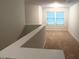 Hallway to second-floor bedroom, with carpet flooring and white walls at 1022 Azimuth Dr, Durham, NC 27713