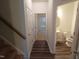 Hallway view to bedroom and bathroom, showing wood and tile flooring, and neutral paint at 1022 Azimuth Dr, Durham, NC 27713
