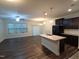A spacious living room and open kitchen area with a large island, modern cabinets, and stainless appliances at 1022 Azimuth Dr, Durham, NC 27713