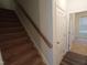 Carpeted stairs lead to upper level, located next to entrance to bedroom at 1022 Azimuth Dr, Durham, NC 27713