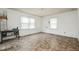 Empty bedroom featuring tile floors, white walls, and two sunny windows at 1066 Shuford Rd, Wake Forest, NC 27587