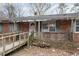 Exterior brick home featuring a front porch and wooden ramp at 1066 Shuford Rd, Wake Forest, NC 27587