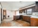 Outdated kitchen with wood cabinets and peeling floor tiles, in need of renovation at 1066 Shuford Rd, Wake Forest, NC 27587