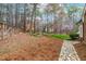 Expansive backyard features a stone path, a wood fence and mature trees at 10726 Trego Trl, Raleigh, NC 27614