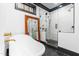 Bright bathroom showcasing a clawfoot tub and modern shower, with black and white accents at 10726 Trego Trl, Raleigh, NC 27614