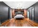 Expansive bedroom with hardwood floors, custom built-ins, ample space, and dark walls and trim at 10726 Trego Trl, Raleigh, NC 27614