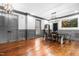 Open dining room with hardwood floors, modern lighting, and gray painted trim at 10726 Trego Trl, Raleigh, NC 27614