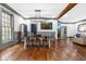Open dining room with hardwood floors, modern lighting, and views into the living space at 10726 Trego Trl, Raleigh, NC 27614