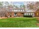 Exterior view of house boasts a brick facade, well-kept lawn and manicured hedges at 10726 Trego Trl, Raleigh, NC 27614