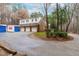 Detached brick garage with three bays, ample parking, and additional loft space, and a circular driveway at 10726 Trego Trl, Raleigh, NC 27614