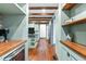 Hallway with wood beams and shelving leads to the kitchen at 10726 Trego Trl, Raleigh, NC 27614
