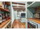 Bright kitchen showcasing wood beam ceilings, custom cabinetry, black countertops, and hardwood floors at 10726 Trego Trl, Raleigh, NC 27614