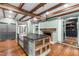 Gourmet kitchen with wood beams, large island, and stainless steel appliances at 10726 Trego Trl, Raleigh, NC 27614