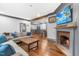 Inviting living room features hardwood floors, fireplace, and TV at 10726 Trego Trl, Raleigh, NC 27614