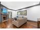 Comfortable living room with a brick fireplace, hardwood floors, and cozy seating at 10726 Trego Trl, Raleigh, NC 27614