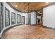 Sunlit living room featuring a brick floor, a wood plank ceiling, gray trim, and expansive windows with views at 10726 Trego Trl, Raleigh, NC 27614