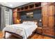Cozy main bedroom with beautiful hardwood floors, built-in storage, and unique lighting at 10726 Trego Trl, Raleigh, NC 27614