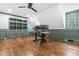 Bright office space with hardwood floors, a ceiling fan, and custom green-trimmed window and baseboards at 10726 Trego Trl, Raleigh, NC 27614