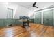 Bright office space with hardwood floors, a ceiling fan, and custom green-trimmed window and baseboards at 10726 Trego Trl, Raleigh, NC 27614